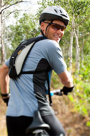 Mountain biker posing in the woods Stock Photo - Premium Royalty-Free, Code: 640-03255532