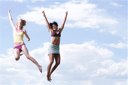 simsearch:640-03255435,k - Two women leaping in the air Stock Photo - Premium Royalty-Free, Code: 640-03255600