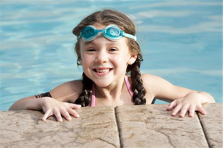 Girl with swimming goggles by pool Stock Photo - Premium Royalty-Free, Code: 640-03255733