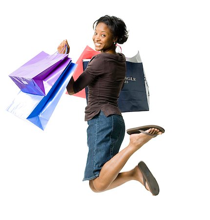 simsearch:640-03261552,k - Woman leaping with gift bags Stock Photo - Premium Royalty-Free, Code: 640-03255791