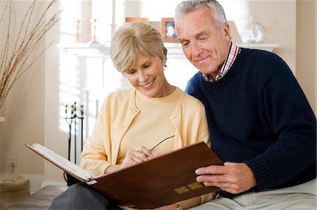 reminiscing photos - Mature couple looking at photo album Stock Photo - Premium Royalty-Free, Code: 640-03255848