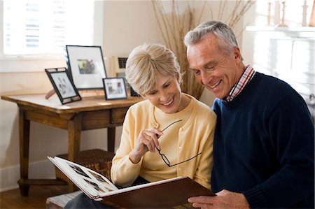 reminiscing photos - Mature couple looking at photo album Stock Photo - Premium Royalty-Free, Code: 640-03255853