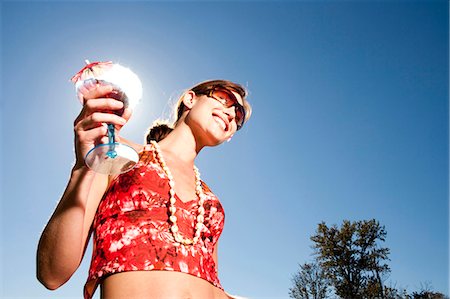 simsearch:640-01353835,k - Woman with cocktail and sunglasses outdoors smiling Stock Photo - Premium Royalty-Free, Code: 640-03255934