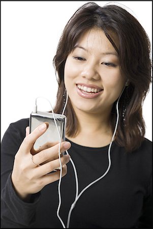 simsearch:640-02773489,k - Woman with mp3 player smiling Fotografie stock - Premium Royalty-Free, Codice: 640-03255962