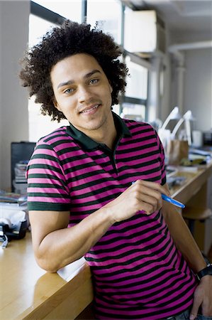 Man leaning on a work table Stock Photo - Premium Royalty-Free, Code: 640-03256013