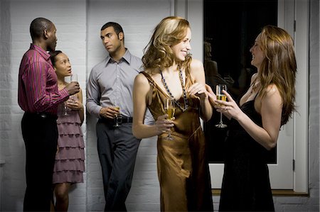 four people chatting - Partygoers socializing Stock Photo - Premium Royalty-Free, Code: 640-03256035