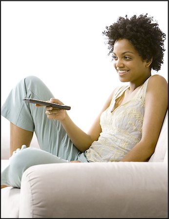 Woman with a remote control Stock Photo - Premium Royalty-Free, Code: 640-03256044