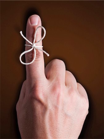 Finger with piece of string tied around it Fotografie stock - Premium Royalty-Free, Codice: 640-03256169