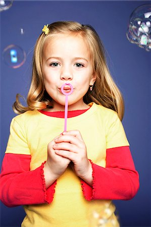 Girl blowing bubbles Stock Photo - Premium Royalty-Free, Code: 640-03256236