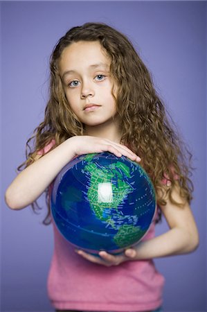 Young girl holding earth globe Stock Photo - Premium Royalty-Free, Code: 640-03256256