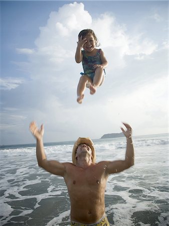 father throwing child - Father tossing his daughter in air Stock Photo - Premium Royalty-Free, Code: 640-03256310