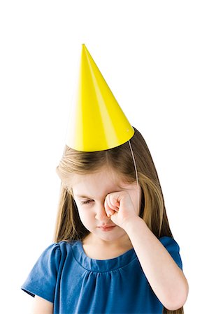 sad person series - Studio portrait of upset girl (4-5) wearing party hat Stock Photo - Premium Royalty-Free, Code: 640-03256420