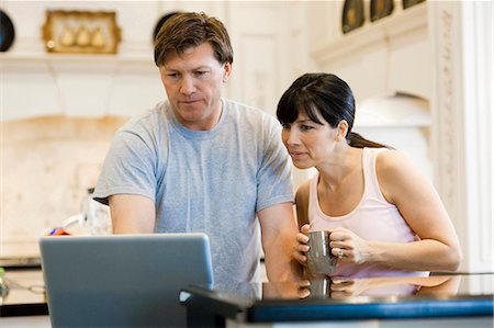 simsearch:640-03256844,k - USA, Utah, couple using laptop in kitchen Stock Photo - Premium Royalty-Free, Code: 640-03256449