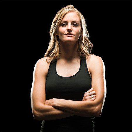 Studio portrait of young woman in tank top Stock Photo - Premium Royalty-Free, Code: 640-03256528