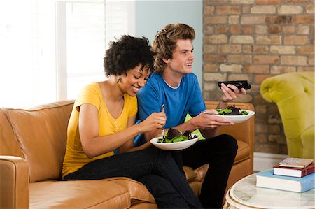 picture of someone watching television side view - USA, Utah, Provo, young couple eating dinner, watching television Stock Photo - Premium Royalty-Free, Code: 640-03256598
