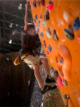 rock climbing indoors full length - USA, Utah, Sandy, boy (12-13) on indoor climbing wall Stock Photo - Premium Royalty-Free, Code: 640-03256618