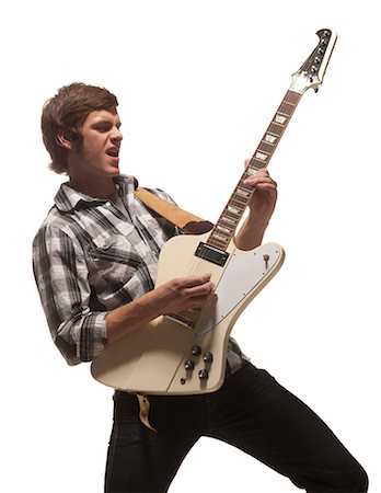 Young man playing guitar, studio shot Foto de stock - Royalty Free Premium, Número: 640-03256629