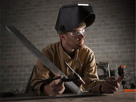 simsearch:640-03256647,k - USA, Utah, Orem, male welder in workshop Stock Photo - Premium Royalty-Free, Code: 640-03256649