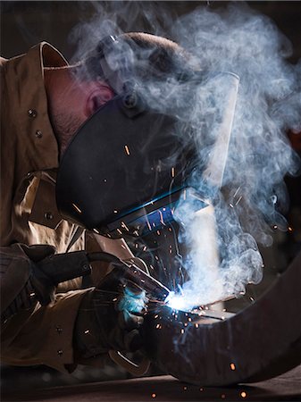 simsearch:640-03256647,k - USA, Utah, Orem, man welding metal Stock Photo - Premium Royalty-Free, Code: 640-03256641