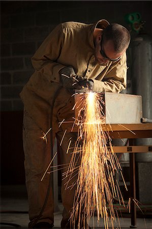 simsearch:640-03256646,k - USA, Utah, Orem, man welding metal in workshop Stock Photo - Premium Royalty-Free, Code: 640-03256656