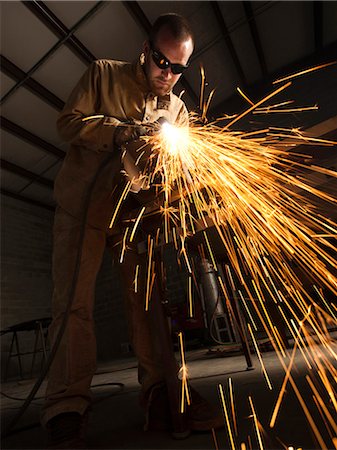 simsearch:640-03256647,k - USA, Utah, Orem, man welding metal in workshop Stock Photo - Premium Royalty-Free, Code: 640-03256657