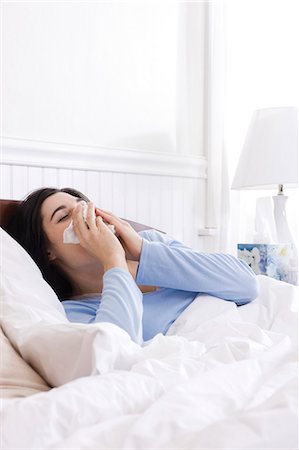 someone about to sneeze - USA, Utah, Orem, young woman sneezing in bed Stock Photo - Premium Royalty-Free, Code: 640-03256704