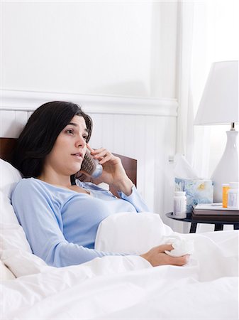 Orem, Utah, USA, young ill woman in bed talking on cordless phone Stock Photo - Premium Royalty-Free, Code: 640-03256712