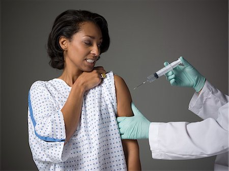 flu shot - Mid adult woman receiving injection Stock Photo - Premium Royalty-Free, Code: 640-03256729