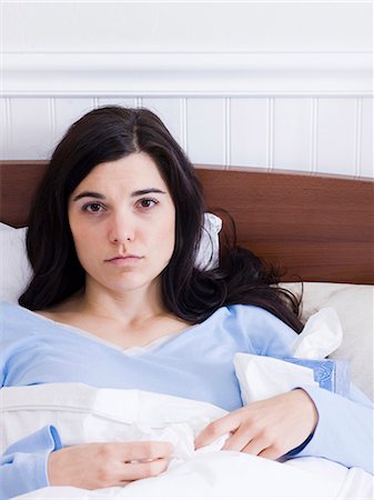 Orem, Utah, USA, young ill woman lying down in bed Stock Photo - Premium Royalty-Free, Code: 640-03256721