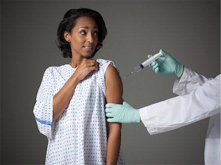 flu shot - Mid adult woman receiving injection Stock Photo - Premium Royalty-Free, Code: 640-03256730