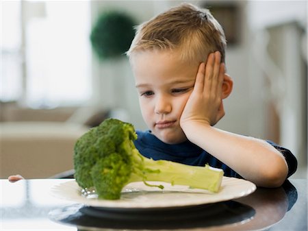 reject food - USA, Utah, Alpine, boy (6-7) resting cheek on hand by plate of broccoli Stock Photo - Premium Royalty-Free, Code: 640-03256860