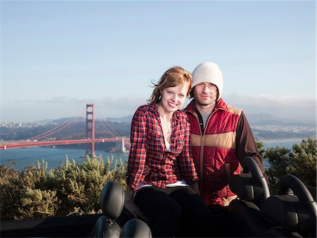 USA, California, San Francisco, young couple sitting, Golden Gate Bridge in background Stock Photo - Premium Royalty-Free, Code: 640-03256926