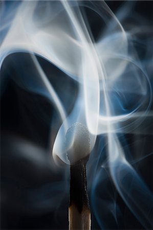 Smoking match against black background Stock Photo - Premium Royalty-Free, Code: 640-03257009