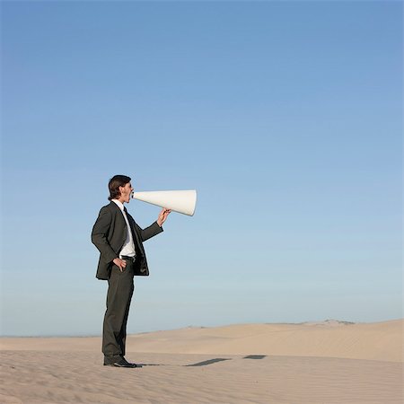 USA, Utah, Little Sahara, businessman shouting through loud speaker in desert Stock Photo - Premium Royalty-Free, Code: 640-03257027