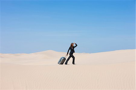 simsearch:640-02951608,k - USA, Utah, Little Sahara, businesswoman pulling suitcase in desert Stock Photo - Premium Royalty-Free, Code: 640-03257040