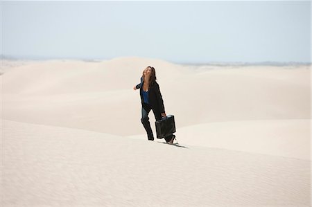 USA, Utah, Little Sahara, young businesswoman walking on desert Stock Photo - Premium Royalty-Free, Code: 640-03257056