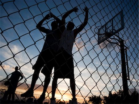 simsearch:640-03257107,k - USA, Utah, Salt Lake City, three young men playing street basketball, low angle view Stock Photo - Premium Royalty-Free, Code: 640-03257089