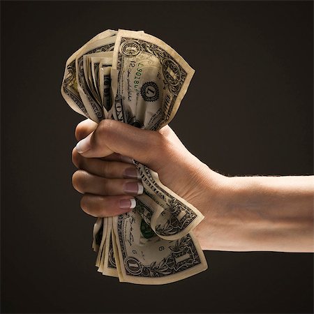 simsearch:640-03257126,k - Young woman's hand holding a wad of US one dollar bills Fotografie stock - Premium Royalty-Free, Codice: 640-03257118