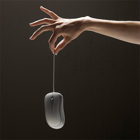 simsearch:640-03257126,k - Young woman's hand holding computer mouse Fotografie stock - Premium Royalty-Free, Codice: 640-03257121