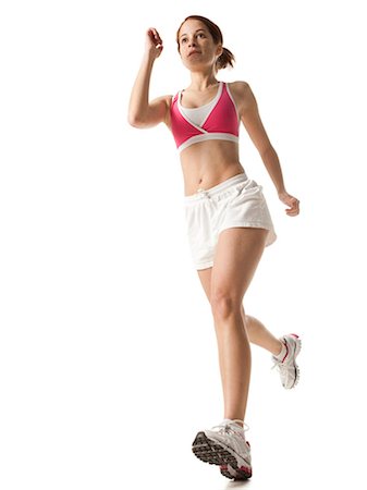 Young woman power walking, studio shot Stock Photo - Premium Royalty-Free, Code: 640-03257184