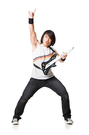 rock bands - Young man playing guitar video game, portrait Stock Photo - Premium Royalty-Free, Code: 640-03257251
