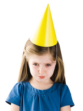 sad lonely girl - Studio portrait of girl (4-5) wearing party hat Stock Photo - Premium Royalty-Free, Code: 640-03257355