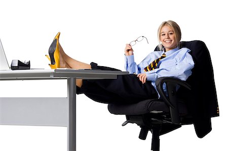 feet up relaxing - Studio portrait of businesswoman relaxing at desk Stock Photo - Premium Royalty-Free, Code: 640-03257515