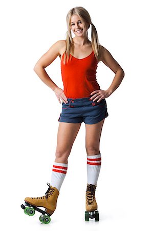 Portrait of young woman wearing roller skates Foto de stock - Sin royalties Premium, Código: 640-03257531