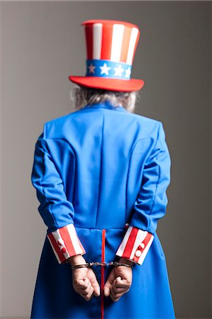 simsearch:640-03257652,k - Man in Uncle Sam's costume as prisoner, studio shot Stock Photo - Premium Royalty-Free, Code: 640-03257622