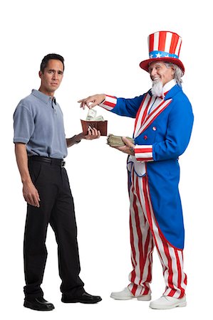 people give money to someone - Man in Uncle Sam's costume taking money from other man, studio shot Stock Photo - Premium Royalty-Free, Code: 640-03257631