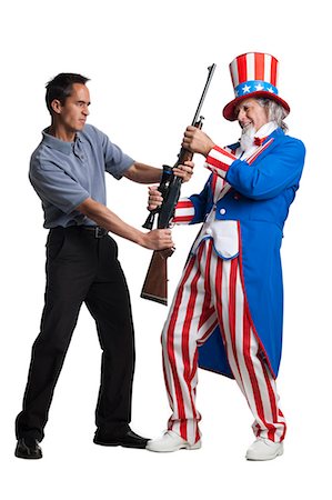 simsearch:640-03257652,k - Man in Uncle Sam's costume seizing gun from other man, studio shot Stock Photo - Premium Royalty-Free, Code: 640-03257633