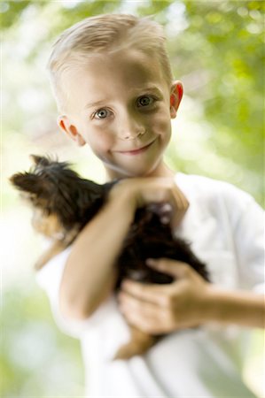 people animal cuddle - Boy holding small dog Stock Photo - Premium Royalty-Free, Code: 640-03257900