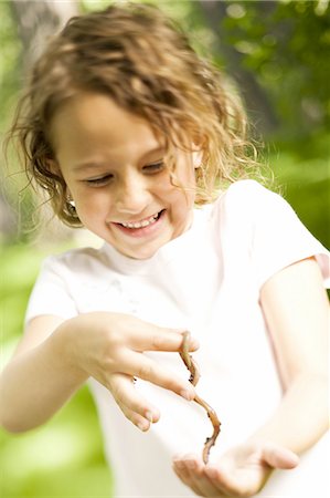 Girl holding stick with ants Stock Photo - Premium Royalty-Free, Code: 640-03257927
