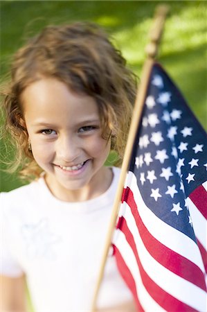 Girl holding US flag Stock Photo - Premium Royalty-Free, Code: 640-03257939